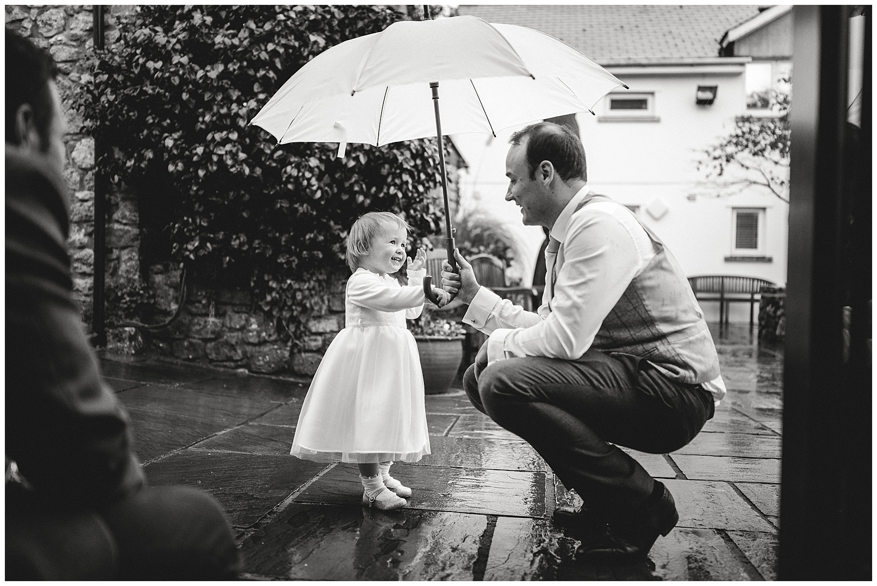 Flower Girl and Dad Under Umbrella